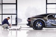 <p>Here, a worker adjusts the Chiron's rear-view camera.</p>