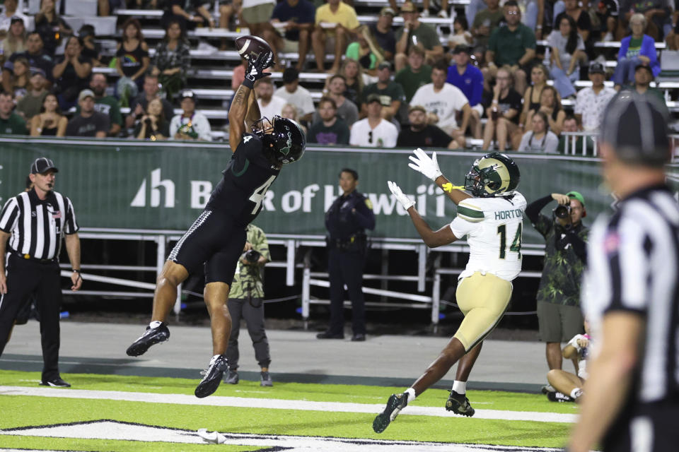 Hawaii defense back Cam Stone (4) breaks up a pass intended for Colorado State wide receiver Tory Horton (14) during the first half of an NCAA college football game Saturday, Nov. 25, 2023, in Honolulu. (AP Photo/Marco Garcia)