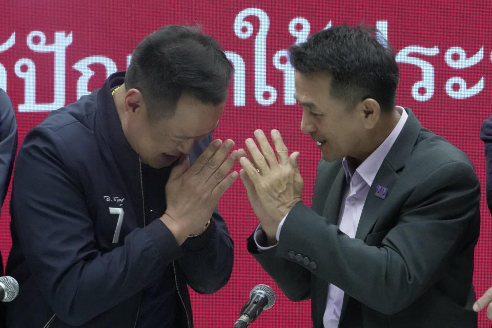 Leader of Bhumjaithai Party Anutin Charnvirakul, left, and Leader of Pheu Thai party Chonlanan Srikaew greet each other after a press conference announcing a coalition party at the Thai Party headquarters in Bangkok, Thailand, Monday, Aug. 7, 2023. The populist Pheu Thai Party on Monday announced it will assemble a coalition with the Bhumjaithai Party from the outgoing administration to solve the months long political deadlock. (AP Photo/Sakchai Lalit)