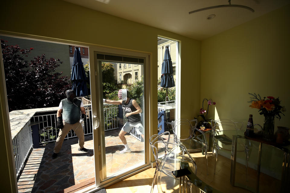 SAN FRANCISCO, CALIFORNIA - MAY 15:  Alexander Massialas (right) trains with his father and coach, Greg Massialas, on their back porch on May 15, 2020 in San Francisco, California. Alexander was on the 2012 and 2016 US Olympic Fencing Team and had planned on being in Tokyo this summer for the 2020 Summer Olympics. He won the silver medal in individual foil and a bronze medal in the team event at the 2016 Olympics. Greg was a member of the 1980, 1984, and 1988 US Olympic Team and is now the national coach for the United States foil team.  Athletes across the globe are now training in isolation under strict policies in place due to the Covid-19 pandemic.  Massialas is now focused on staying in shape and getting ready for the Olympics in Tokyo in 2021.  (Photo by Ezra Shaw/Getty Images)