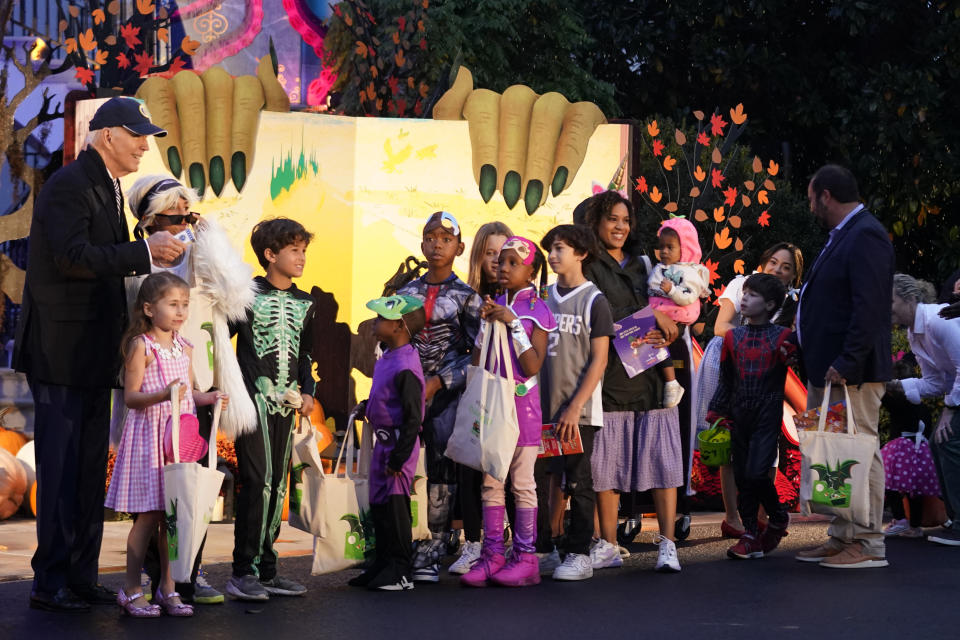 President Joe Biden poses for a photo with trick-or-treaters on the South Lawn of the White House, on Halloween, Monday, Oct. 30, 2023. (AP Photo/Andrew Harnik)