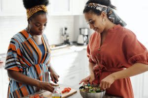 Two Black women cooking in the kitchen together