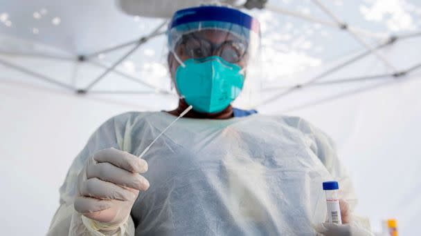 PHOTO: A health worker takes a nasal swab sample at a COVID-19 testing site in Los Angeles, July 24, 2020. (Valerie Macon/AFP via Getty Images, FILE)