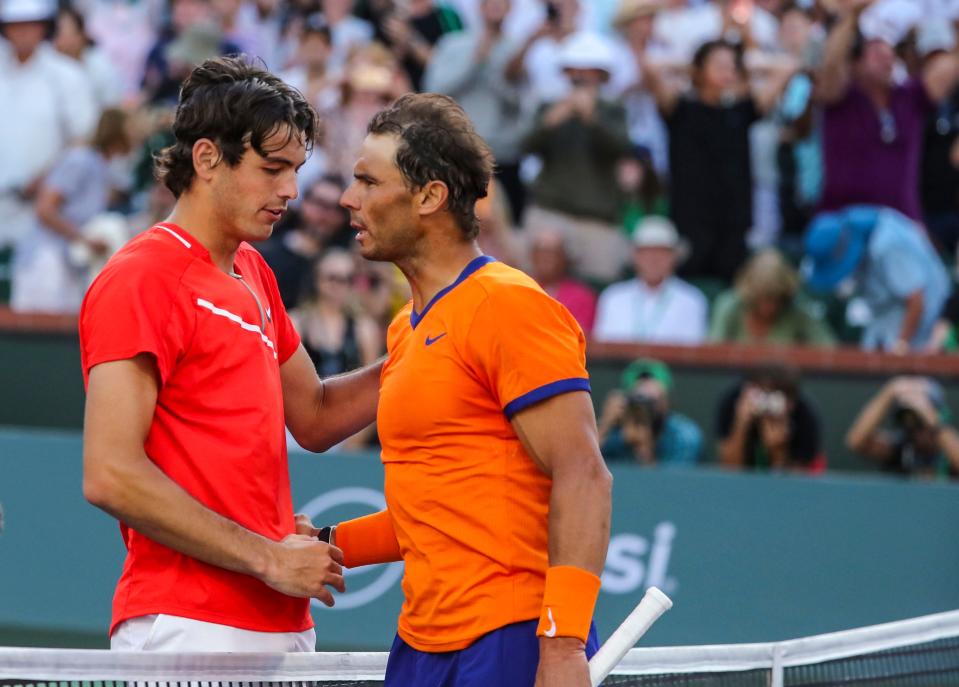 Taylor Fritz of the United States (left) shakes hands with Rafael Nadal of Spain after defeating him in the ATP singles final at the BNP Paribas Open at the Indian Wells Tennis Garden in Indian Wells, Calif., Sunday, March 20, 2022. 