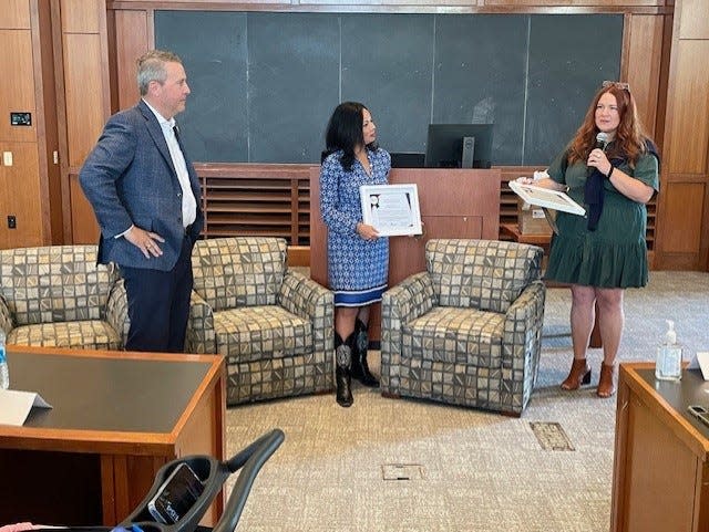 State Rep. Brad Buckley (left) watches as Texas Humane Legislative Network Executive Director Shelby Bobosky (right) presents the Humane Hero Award to state Rep. Claudia Ordaz. Ordaz and Buckley were recognized by the group during an event Saturday, April 13, 2024.