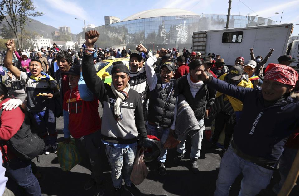 Anti-government protesters cheer as they wait for a bus to return them home, in the aftermath of violent protests against the government, in Quito, Ecuador, Monday, Oct. 14, 2019. Ecuador celebrated a deal President Lenín Moreno and indigenous leaders struck late Sunday to cancel a disputed austerity package and end nearly two weeks of protests that have paralyzed the economy and left seven dead. (AP Photo/Fernando Vergara)