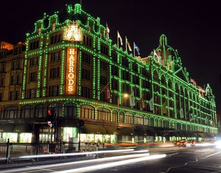 Vehicles drive past the Harrods retail store in London, Britain, in this October 29, 2009 file photo. REUTERS/Toby Melville/Files