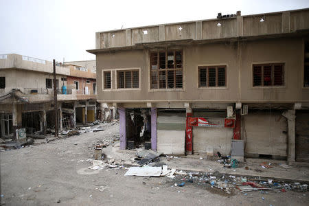 Buildings damaged during fighting are seen on an empty street in western Mosul, Iraq, April 11, 2017. REUTERS/Andres Martinez Casares