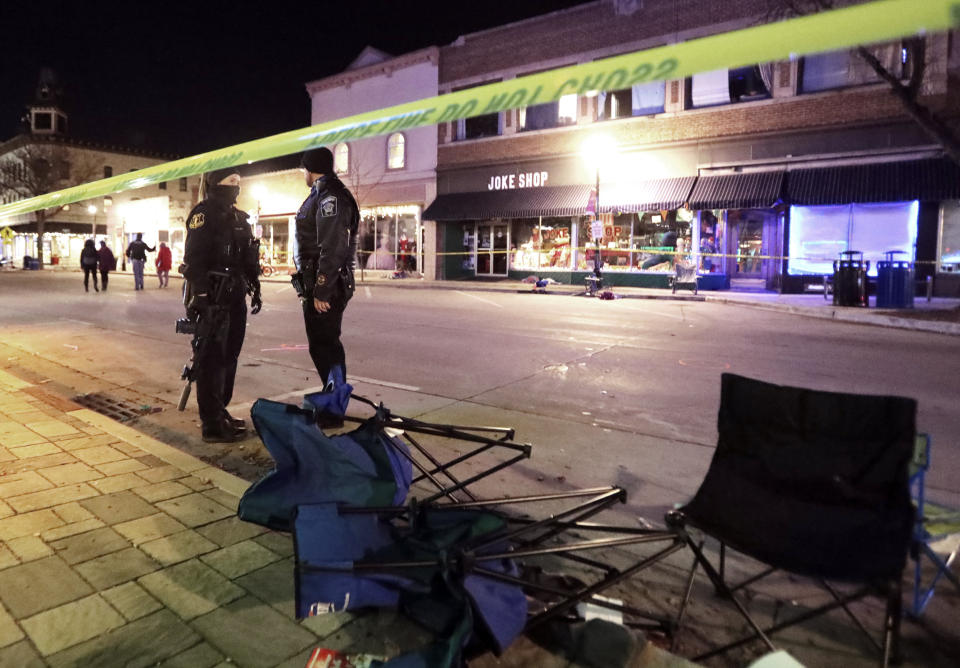 Image: Police stand near toppled chairs lining W. Main St. in downtown Waukesha, Wis., after an SUV drove into a parade of Christmas marchers (John Hart / Wisconsin State Journal via AP file)