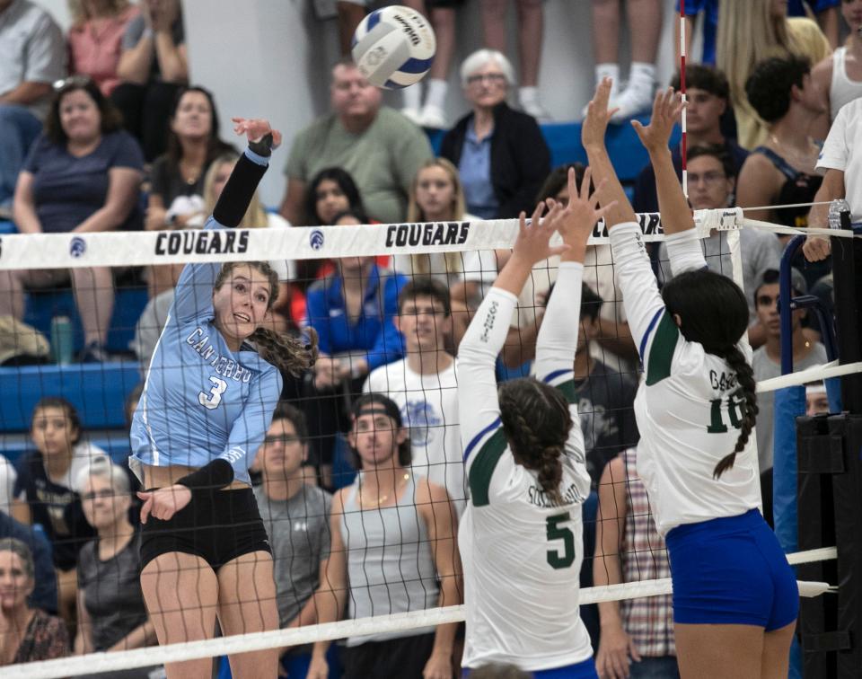 Brighten Sedmack of Canterbury hits over Isabelle Soderlund and  Adriana Garcia of Seacrest in the championship match of the Private 8 Volleyball tournament on Thursday, Sept. 15, 2022, at The Canterbury School in Fort Myers.