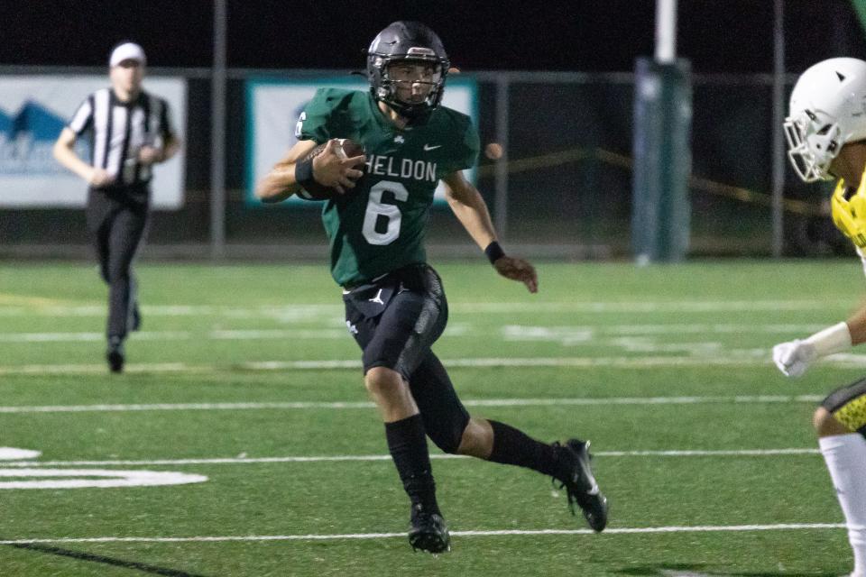 Sheldon quarterback Colby Parosa sprints away from a defender against the Mililani Trojans of Hawaii in a 37-3 loss at home Sept. 1, 2023.