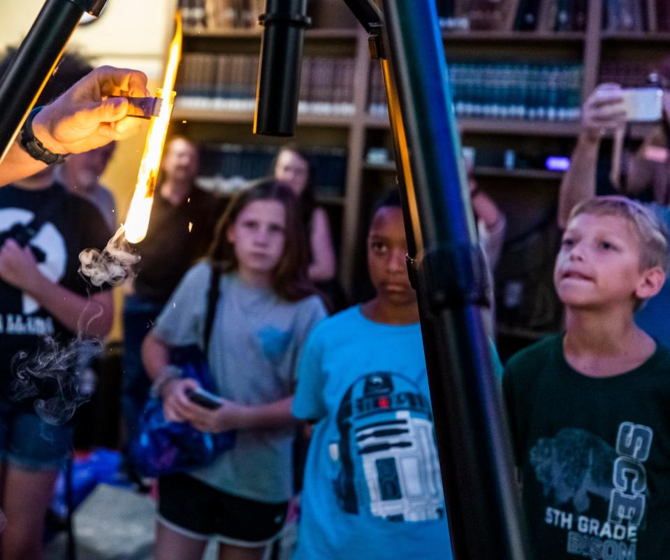 Kids attending a camp at Dyer Observatory observe as astronomer Dr. Billy Teets conducts an experiment Friday, July 12, 2019.