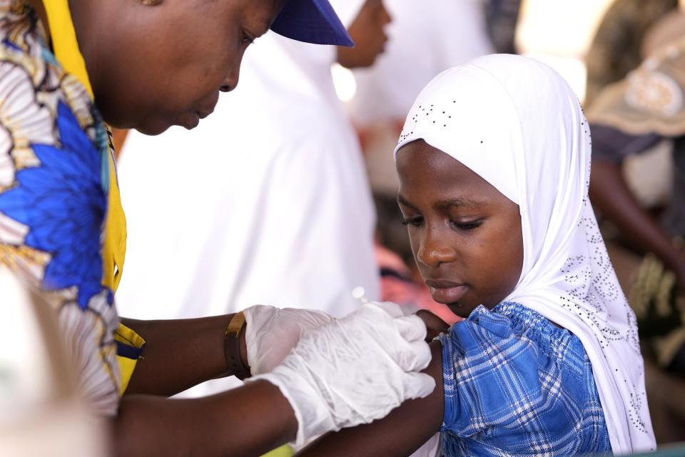 A health worker administers a cervical cancer vaccine HPV Gardasil to a girl on the street in Ibadan, Nigeria, on May 27, 2024. African countries have some of the world's highest rates of cervical cancer. Growing efforts to vaccinate more young girls for the human papillomavirus are challenged by the kind of vaccine hesitancy seen for some other diseases. Misinformation can include mistaken rumors that girls won't be able to have children in the future. Some religious communities must be told that the vaccine is "not ungodly." More than half of Africa's 54 nations – 28 – have introduced the vaccine in their immunization programs, but only five have reached the 90% coverage that the continent hopes to achieve by 2030. (AP Photo/Sunday Alamba)