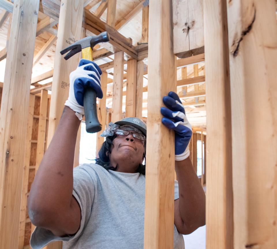 Future homeowner Freda Hale acrues sweat equity hours by helping to build a Habitat for Humanity house for another family partner in Pensacola on Tuesday, Sept. 27, 2022.