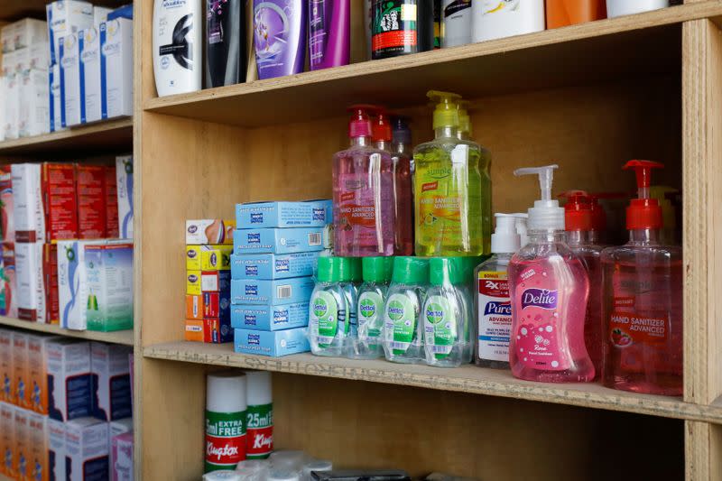 Bottles of hand sanitizers are seen in a shelf for sale, amid coronavirus outbreak, at a medical store in Karachi