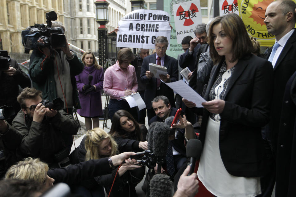 Singer Charlotte Church, right, speaks to the media outside the High Court in London after hearing the reading of a statement setting out the terms of the settlement for phone hacking damages claim against News International, Monday, Feb. 27, 2012. Church, who testified before a media inquiry of being hounded by Rupert Murdoch's journalists when she was a teen singing sensation, received 600,000 pounds ($951,000) Monday in a phone hacking settlement from News International and said she had been sickened by what she had learnt about intrusion into her private life. (AP Photo/Sang Tan)