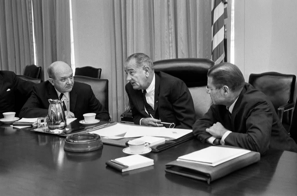 Secretary of Defense Robert McNamara (right), President Lyndon Johnson and Secretary of State Dean Rusk, seated at a table after McNamara's return from South Vietnam, in Washington, on July 21, 1965.