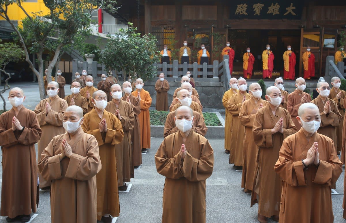 Monks and nuns pray together during Buddha's birthday celebrations at the Lin Chi Temple in Taipei, Taiwan, on May 9, 2021 (AP)