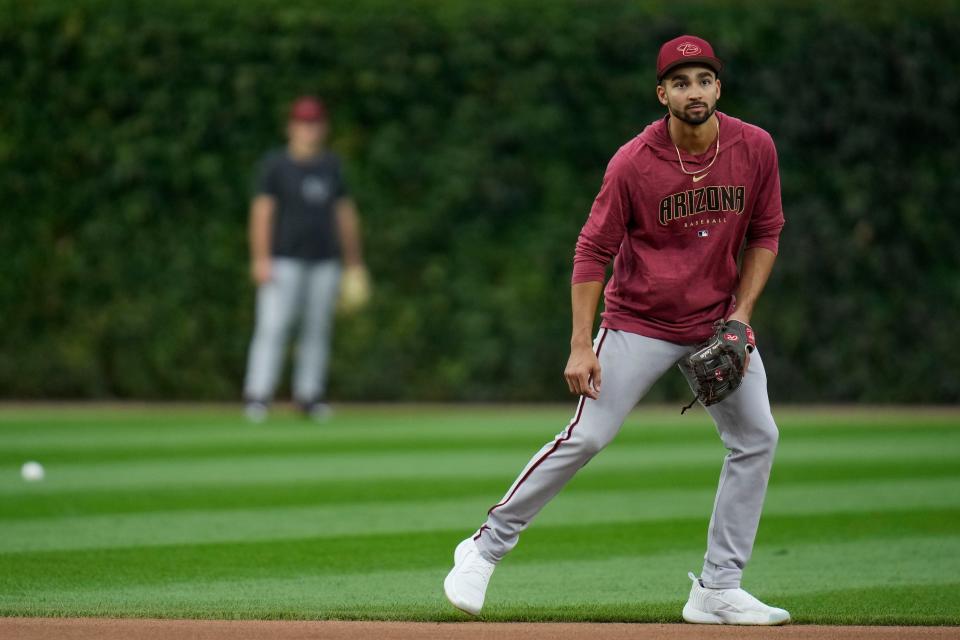 Arizona Diamondbacks' Jordan Lawlar warms up before the team's baseball game against the Chicago Cubs, in which he was expected to make his debut in the majors, Thursday, Sept. 7, 2023, in Chicago. (AP Photo/Erin Hooley)