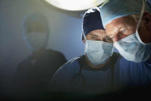 Close-up of two doctor's faces while performing surgery