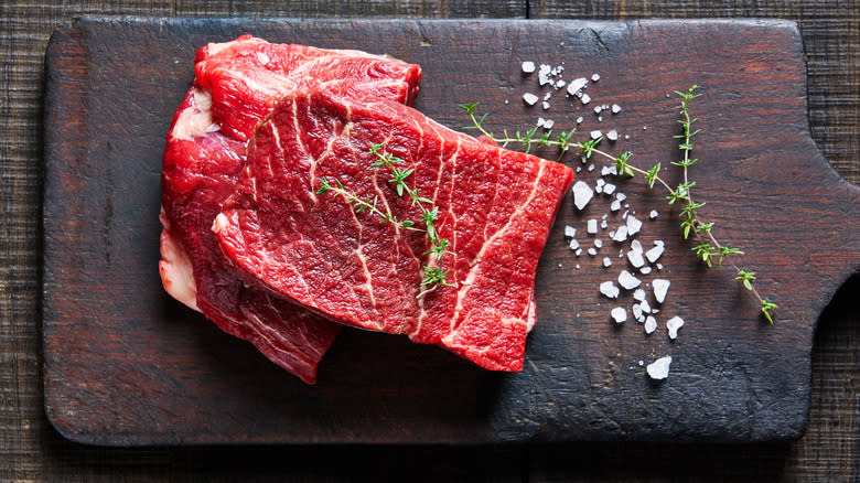 Two raw flat iron steaks.