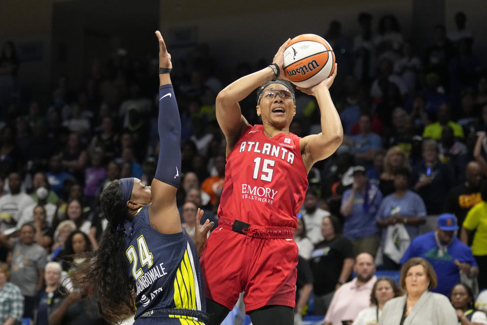 Atlanta Dream guard Allisha Gray (15) shoots as Dallas Wings guard Arike Ogunbowale (24) defends during the first half of Game 2 of a first-round WNBA basketball playoff series Tuesday, Sept. 19, 2023, in Arlington, Texas. (AP Photo/Tony Gutierrez)