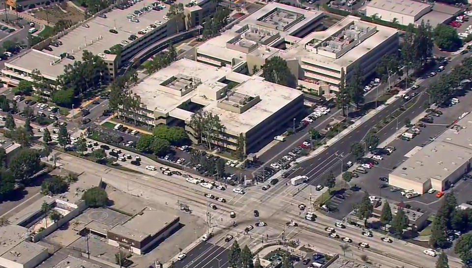 This photo from video provided by ABC7 Los Angeles shows dozens of law enforcement vehicles surrounding Kaiser Permanente Downey Medical Center, following reports of someone with a weapon at the facility in Downey, Calif., Tuesday, Sept. 11, 2018. Los Angeles County sheriff's officials say a suspect is in custody and deputies and police officers are methodically searching the complex. (ABC7 Los Angeles via AP)