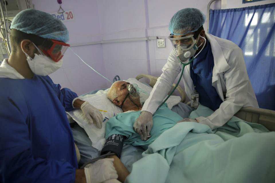 FILE - In this Sunday, June 14, 2020 file photo, medical workers attend to a COVID-19 patient in an intensive care unit at a hospital in Sanaa, Yemen. Researchers in England say they have the first evidence that a drug can improve survival from COVID-19. The drug is a cheap, widely available steroid called dexamethasone. Results released Tuesday, June 16 show it reduced deaths by up to one third in severely ill hospitalized patients. (AP Photo/Hani Mohammed, File)