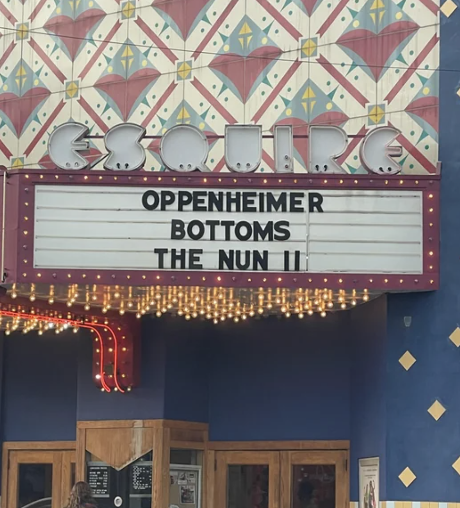 Three-line movie-theater awning: "Oppenheimer / Bottoms / The Nun II"