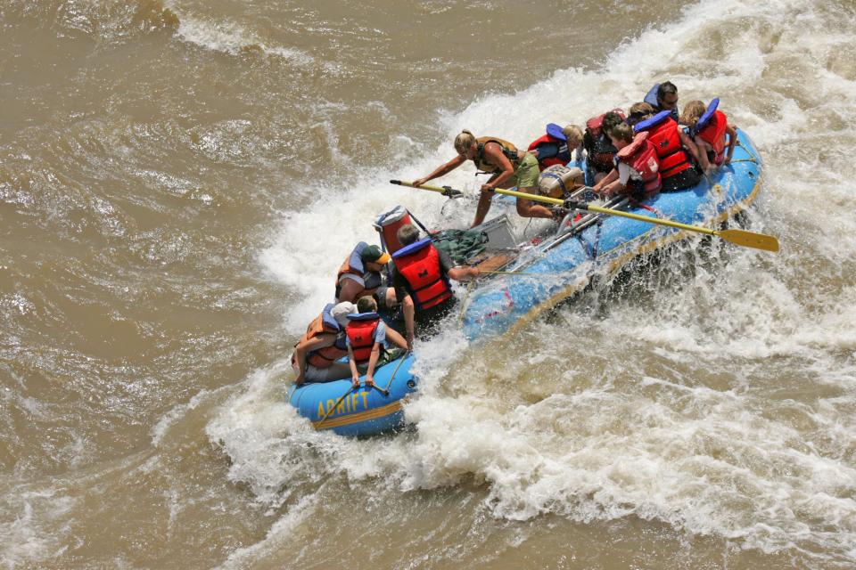 A river guide pilots an Adrift Adventures boat through the Colorado River rapids. Record high flows are expected this year. | Adrift Adventures