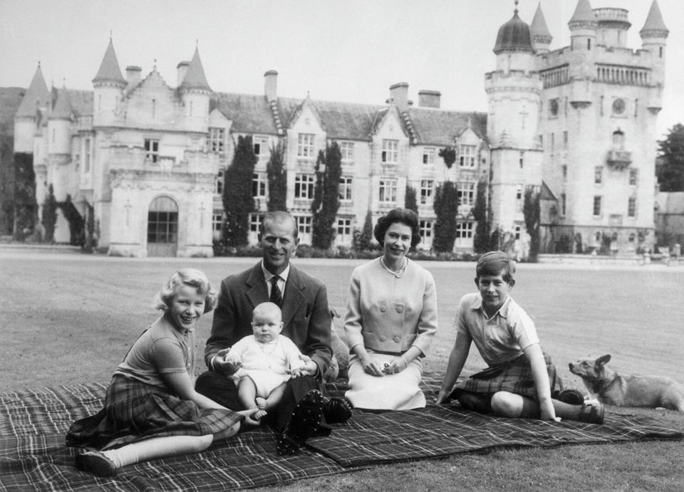 Queen Elizabeth II and Prince Philip, Duke of Edinburgh with their children, Prince Andrew (centre), Princess Anne (left) and Charles, Prince of Wales sitting on a picnic rug outside Balmoral Castle in Scotland, 8th September 1960.