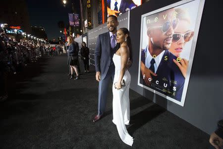 Cast member Will Smith and his wife Jada Pinkett Smith pose at the premiere of "Focus" at the TCL Chinese theatre in Hollywood, California February 24, 2015. REUTERS/Mario Anzuoni