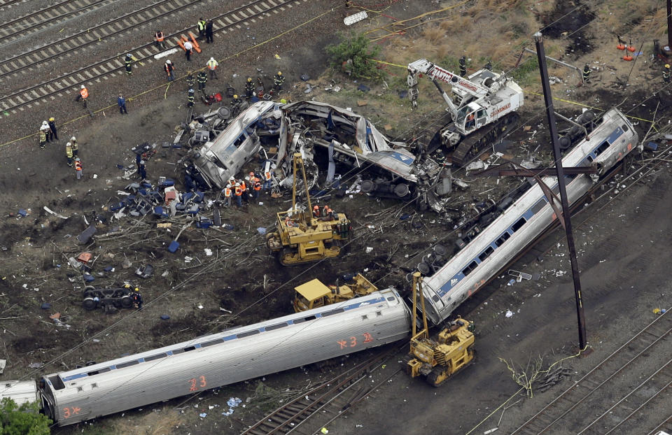 Emergency personnel work at the scene of a deadly train derailment, Wednesday, May 13, 2015, in Philadelphia. The Amtrak train, headed to New York City, derailed and crashed in Philadelphia on Tuesday night, killing at least six people and injuring dozens of others. (AP Photo/Patrick Semansky)