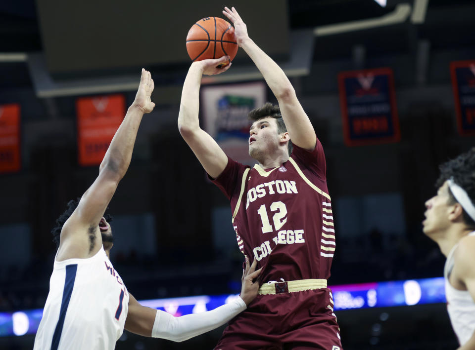 FILE - Boston College forward Quinten Post (12) shoots between Virginia forward Jayden Gardner (1) and Virginia forward Kadin Shedrick (21) during an NCAA college basketball game in Charlottesville, Va., Tuesday, Feb. 1, 2022. Boston College is hoping continuity leads to more success in the second year under coach Earl Grant.(AP Photo/Andrew Shurtleff, File)