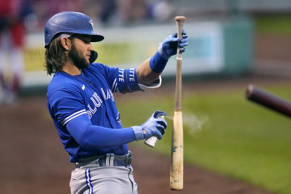 Toronto Blue Jays' Bo Bichette applies bat grip spray while preparing in the on-deck circle prior to his first inning at bat during a baseball game against the Boston Red Sox at Fenway Park, Monday, June 14, 2021, in Boston. (AP Photo/Charles Krupa)