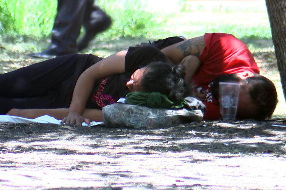 Migrants rest at a park during a hot day in July, in San Antonio. (Austin Anderson)