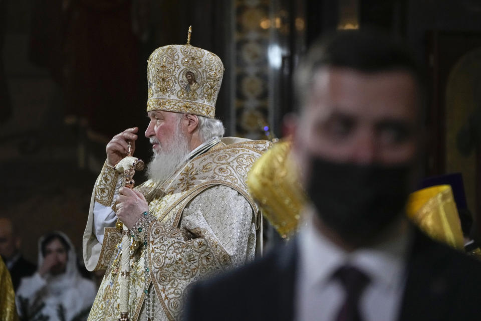 Russian Orthodox Patriarch Kirill delivers a Christmas service in the Christ the Saviour Cathedral in Moscow, Russia, Friday, Jan. 6, 2023, with an officer of the Federal Security Service in the foreground. Orthodox Christians celebrate Christmas on Jan. 7, in accordance with the Julian calendar. (AP Photo/Alexander Zemlianichenko, Pool)