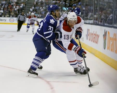 Oct 7, 2015; Toronto, Ontario, CAN; Toronto Maple Leafs forward Mark Arcobello (33) goes to check Montreal Canadiens forward Alexander Semin (13) at the Air Canada Centre. John E. Sokolowski-USA TODAY Sports