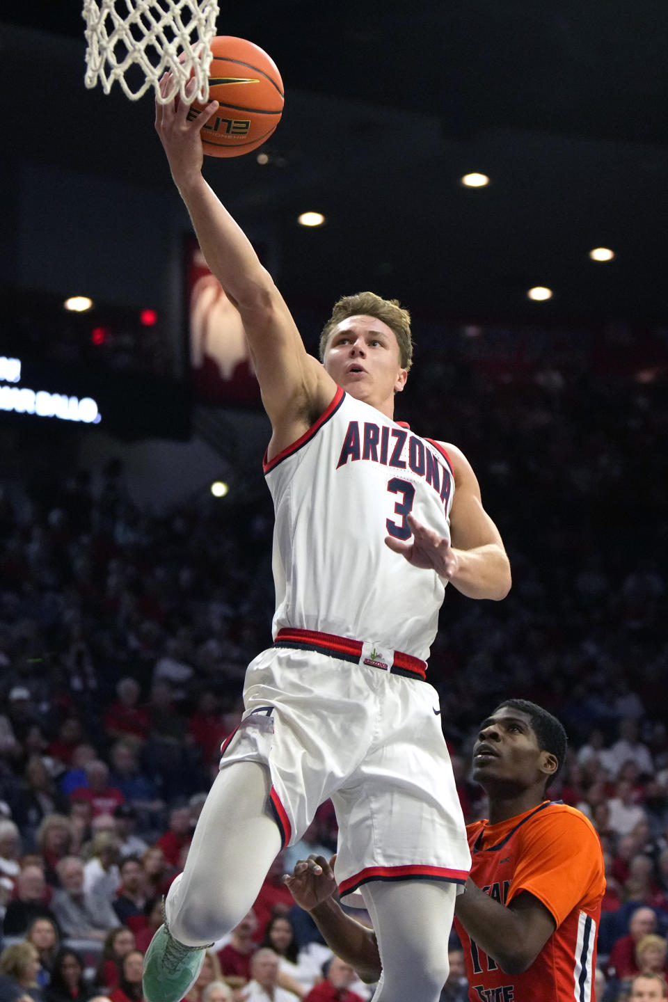 Arizona guard Pelle Larsson (3) shoots over Morgan State guard Ahmarie Simpkins during the second half of an NCAA college basketball game Monday, Nov 6, 2023, in Tucson, Ariz. (AP Photo/Rick Scuteri)