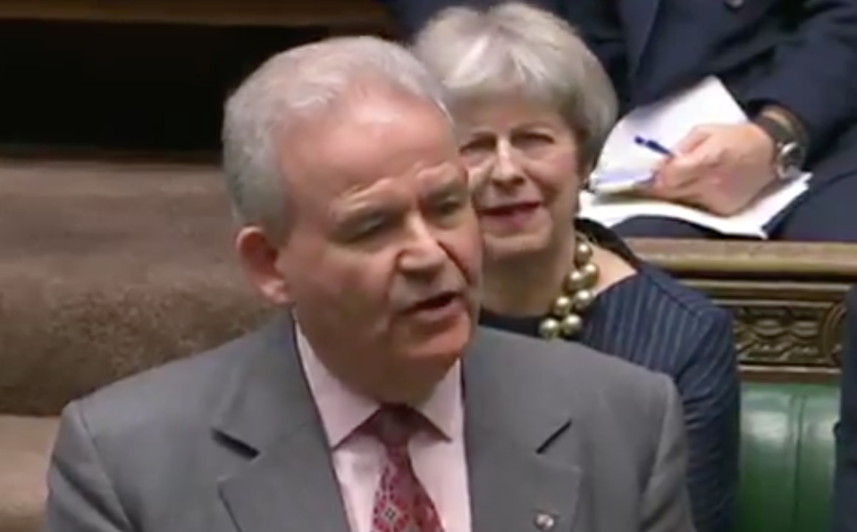 Theresa May could be seen pulling a face behind Julian Lewis. 