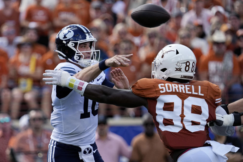 BYU quarterback Kedon Slovis (10) throws under pressure from Texas defensive end Barryn Sorrell (88) during the first half of an NCAA college football game in Austin, Texas, Saturday, Oct. 28, 2023. (AP Photo/Eric Gay)