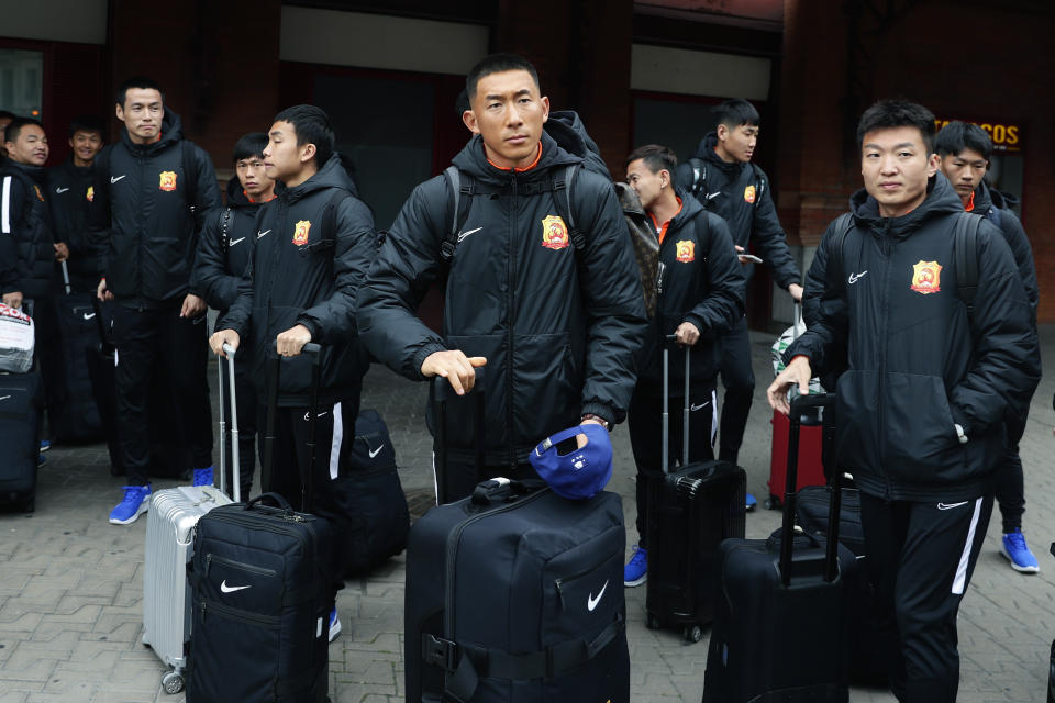 Players of the Chinese Super League team Wuhan Zall arrive at the Atocha train station in Madrid, Spain, Saturday, Feb. 29, 2020. The Chinese first-division soccer club from the city of Wuhan enters its second month in Spain without knowing when it will be able to return home. . It hasn't been easy for the nearly 50 members of the Wuhan Zall squad, but on Sunday they will get some reprieve from their ordeal by attending the Spanish league "clasico" between Real Madrid and Barcelona at the Santiago Bernabeu Stadium in Madrid. (AP Photo/Manu Fernandez)