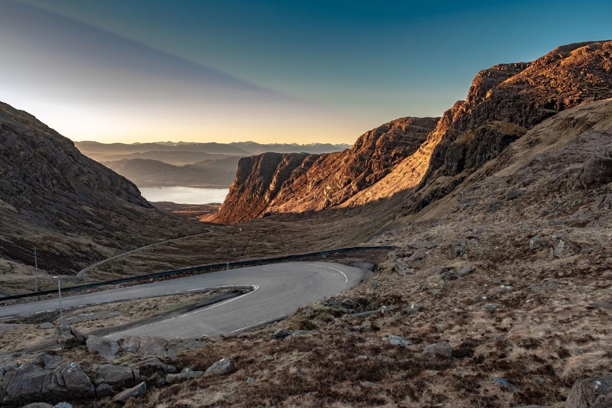 Looking down on the hairpin bends of the Bealach na Ba in Wester Ross, Scotland, at sunrise.