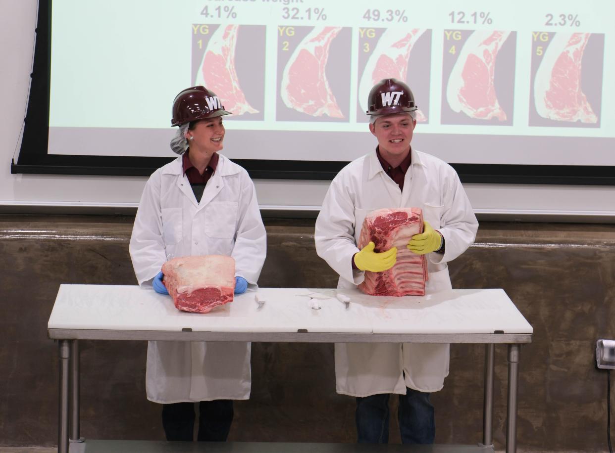 Two members of the WT meat judging team explain how beef is graded Tuesday at a One West Campaign Steering Committee Meeting at West Texas A&M.