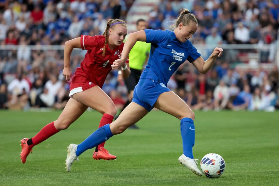 BYU’s Olivia Smith-Griffitts (2) moves the ball ahead of Utah’s Alex Schoenstadt (4) during the game at Ute Field in Salt Lake City on Saturday, Sept. 9, 2023. | Spenser Heaps, Deseret News