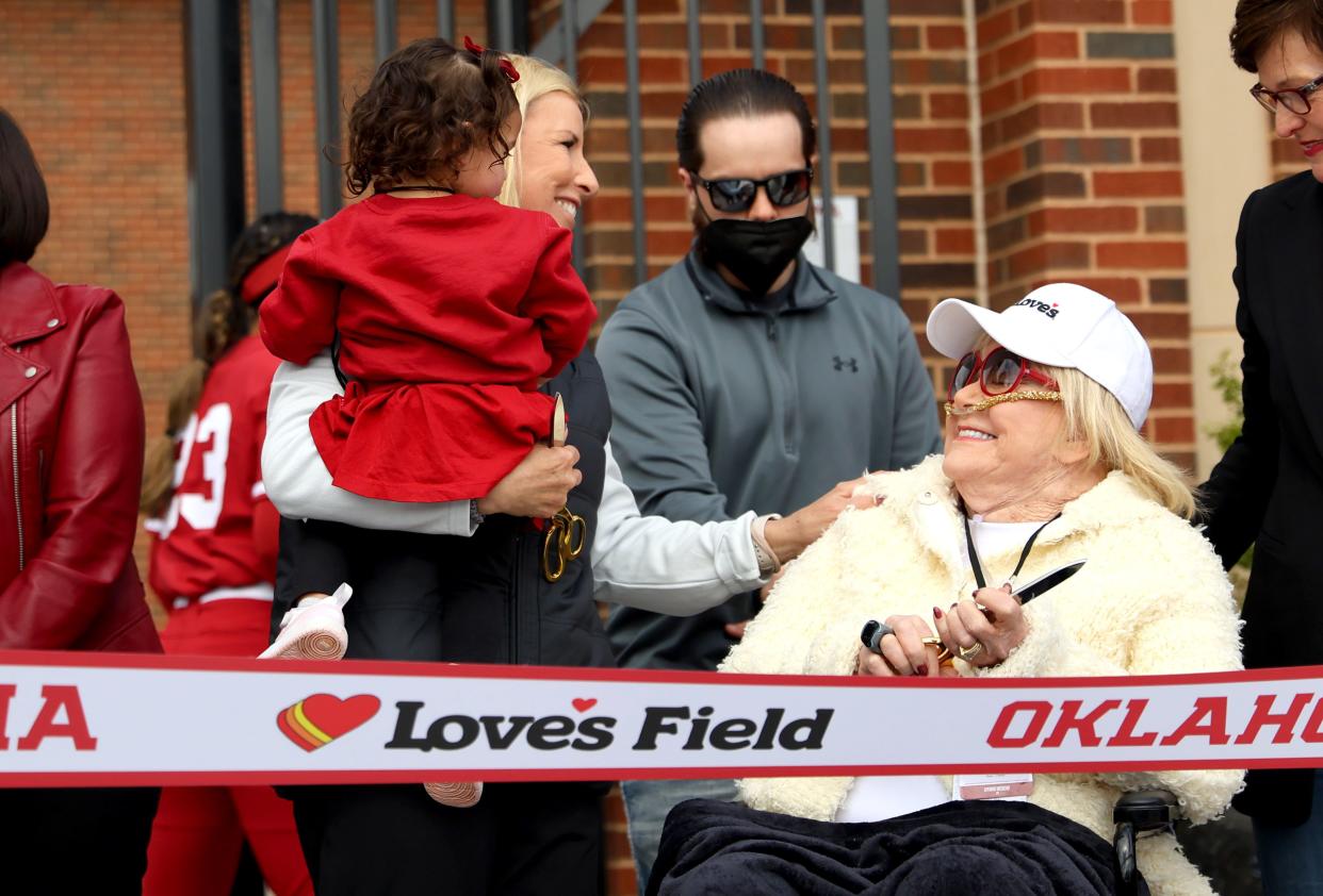 Oklahoma head softball coach Patty Gasso, holds granddaughter Ava June Gasso, as she talks with Judy Love on March 1 during the grand opening of the the University of Oklahoma Love's Field softball stadium in Norman.