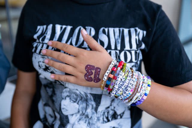 <p>Amanda Edwards/Getty</p> Taylor Swift fan with friendship bracelets