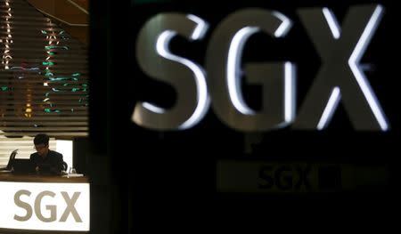 An employee works at a front desk of the Singapore Exchange head office in Singapore April 22, 2015. REUTERS/Edgar Su/File Photo