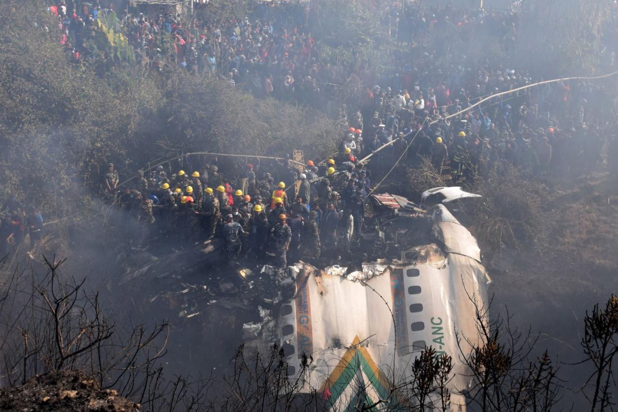 Mandatory Credit: Photo by KRISHNA MANI BARAL/EPA-EFE/Shutterstock (13715777l) A general view of rescue teams working near the wreckage at the crash site of a Yeti Airlines ATR72 aircraft in Pokhara, central Nepal, 15 January 2023. A Yeti Airlines ATR72 aircraft carrying 72 people on board, 68 passengers and 4 crew members, crashed into a gorge while trying to land at the Pokhara International Airport. According to a statement from the Civil Aviation Authority of Nepal (CAAN), at least 68 people were confirmed dead. Yeti Airlines ATR72 aircraft carrying 68 passengers and 4 crew members crashes in Pokhara, Nepal - 15 Jan 2023