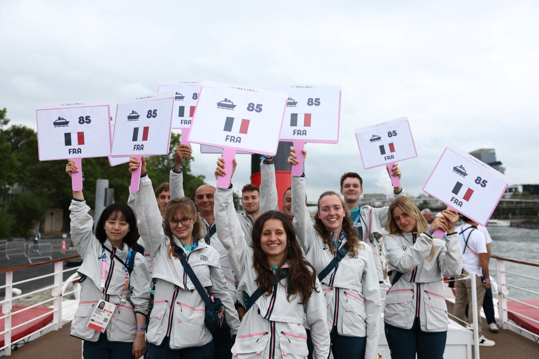 Volunteers pose on the French delegation boat  on the river Seine prior to the opening ceremony of the Paris 2024 Olympic Games in Paris on July 26, 2024. (Photo by Franck FIFE / POOL / AFP) (Photo by FRANCK FIFE/POOL/AFP via Getty Images)